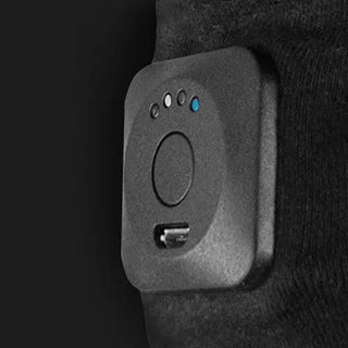 Black Intellinetix wearable vibration therapy gloves with rechargeable control module, breathable cotton fabric, and anti-slip grip pattern.