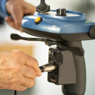 A hand connecting the tiller cable to the control panel of a Journey So Lite 08474 scooter.