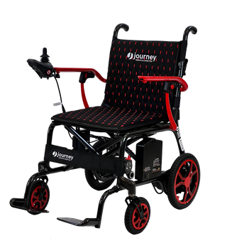 Red and black Journey Air Elite 08642 power chair with cushioned seat and footplate