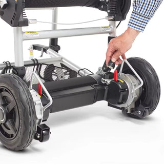 A hand moving the red brake lever beside the rear wheel of the Journey Zoomer 09017 between drive and free wheeling.