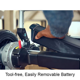 A hand lifting the removable lithium-ion battery out of the Journey Zoomer 09017 power chair.