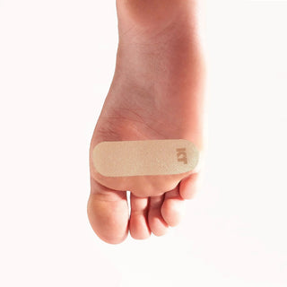 KT Health Blister Prevention Tape applied to the bottom of a foot