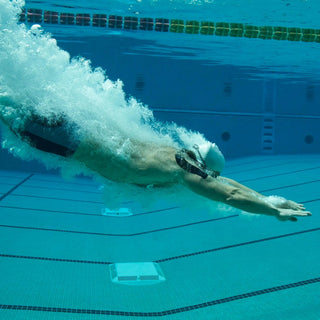 Runner wearing KT Tape Pro Extreme kinesiology tape in wet conditions