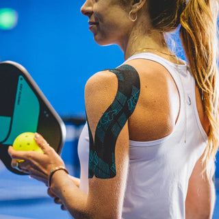 Pickleball player wearing KT Tape Pro Ice menthol kinesiology tape on the shoulder
