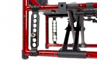 Close-up of a red metal frame with black components on a white background