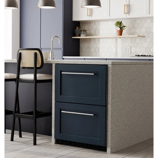 Modern kitchen with dark blue KoolMore KM-BIR2D-PR Panel Ready Drawer Refrigerator, light gray countertop, and bar stool.