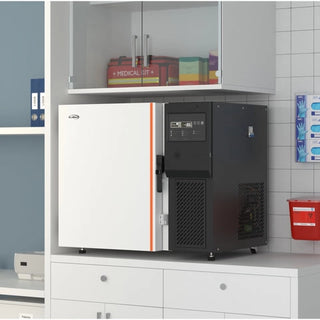 KoolMore KM-PHF-4CUL Ultra Low Temp Stackable Medical Freezer in a medical setting with cabinets and shelves.