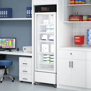 White KoolMore KM-PHR-11C Medical Pharmacy Refrigerator, 11 cu. ft. in a clinical setting with shelves and equipment.
