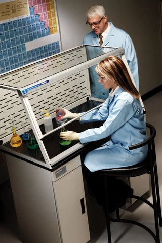 Two scientists in a laboratory setting, working at a Labconco 3 Feet Protector XVS Ventilation Station, 22.8 or 32 Inch High, 115V or 230V, 50-60Hz