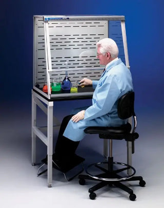 Person in a lab coat working at a Labconco 3 Feet Protector XVS Ventilation Station, 22.8 or 32 Inch High, 115V or 230V, 50-60Hz with various items on a blue background