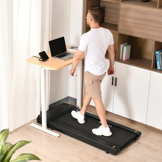 Man using a Lifespanfitness TR1200BPro-SC130 Omni GlowUp Under Desk Treadmill attached to a standing desk in a home office setting.