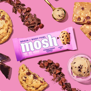 Wrapped MOSH Cookie Dough Crunch Protein Bar surrounded by its flavor ingredients