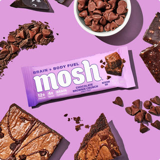Wrapped MOSH Chocolate Brownie Crunch Protein Bar surrounded by its flavor ingredients