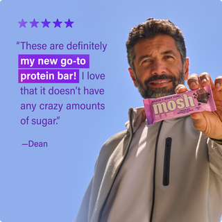 Customer holding a MOSH protein bar next to a written review