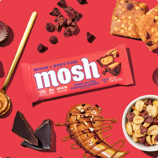 Wrapped MOSH Peanut Butter Chocolate Crunch Protein Bar surrounded by its flavor ingredients