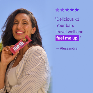Customer holding a MOSH protein bar next to a written review