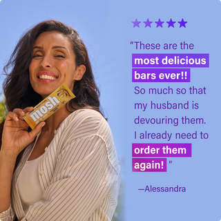 Customer holding a MOSH protein bar next to a written review