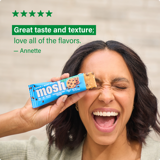 Customer holding a MOSH protein bar next to a written review