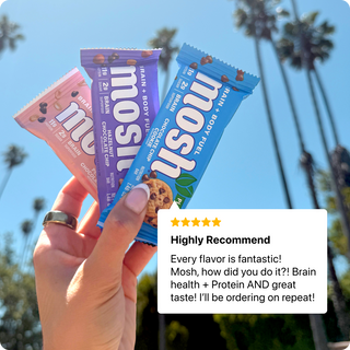 Hand holding MOSH plant-based bars beside a customer review