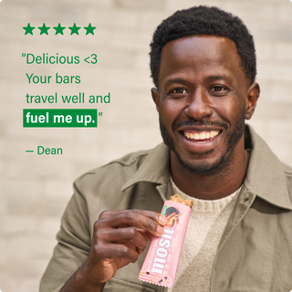 Customer holding a MOSH protein bar next to a written review