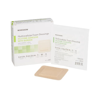 McKesson 886432_CS Foam Dressing 5-Layer 4 X 4 In w/Border Film Backing Silicone Sacral Sterile with packaging on a white background