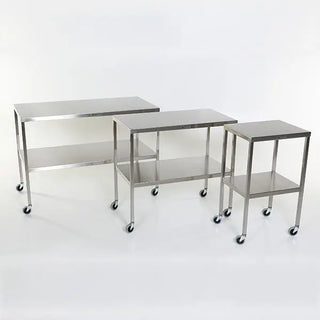 Three stainless steel MidCentral Instrument-Back Tables with Shelf with wheels on a white background