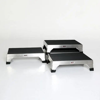 Set of three metal MidCentral MCM-140 Stacking-Interlocking Step Stool with black platforms on a white background