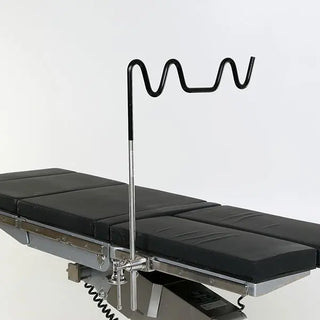 Medical examination table with a MidCentral MCM611 Picket Fence Leg Holder on a white background