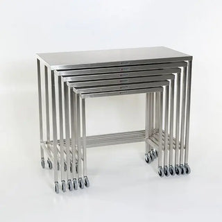 Set of six stainless steel MidCentral Nesting Tables on a white background