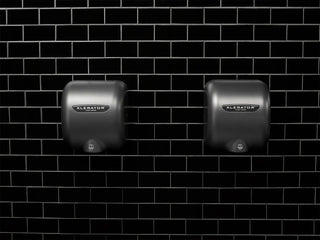 Graphite textured XLERATOR hand dryer with a dark painted finish, automatic touch-free activation, high-speed drying performance, and wall-mounted installation for commercial restrooms.
