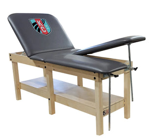 Pivotal Health 6 Leg Edge Sport Wood Treatment Table with a logo on the backrest against a white background