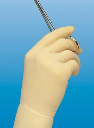 Hand wearing a beige Protexis™ 995376_CS Surgical Glove Size 6.5  holding a small tool against a blue background