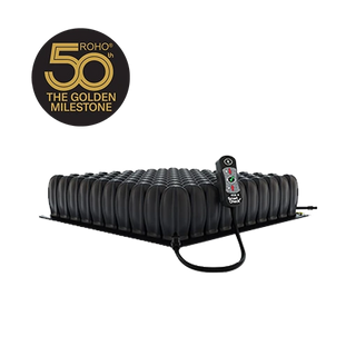 Black ROHO® HIGH PROFILE® Single Compartment Sensor Ready® Wheelchair Cushion with remote control on a white background, featuring Roho's 50th anniversary logo.