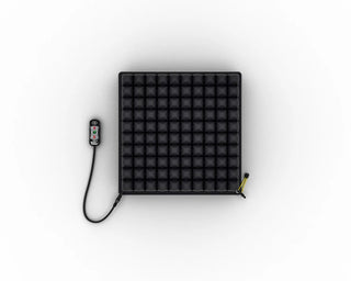 Black ROHO® Single Compartment Sensor Ready Wheelchair Cushion, Mid Profile with a remote control on a white background