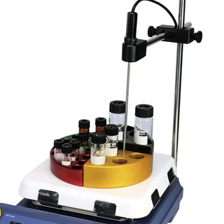 Rotating sample holder with various vials on a white background