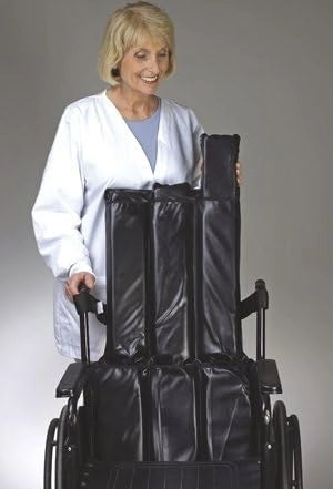 Person in a white coat holding a black wheelchair cover against a gray background