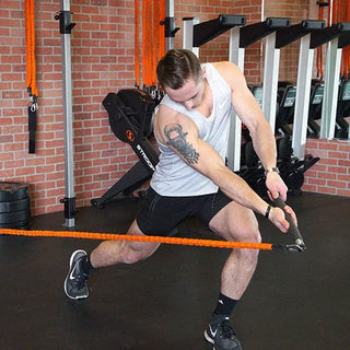 The Stroops FITSTIK Fit Stik Bar is a compact aluminum training bar with a slim cylindrical design, comfortable anti-slip handling, and swivel eyelets at the ends for attaching resistance bands or cable machine connections. Its compact size is suitable for portable full-body resistance training.