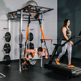 The Stroops FSPR Performance Rack is a sleek, low-profile black fitness station with a sturdy rack structure, adjustable J-hooks for Olympic barbells, four resistance band anchor points, and upper storage space for workout equipment. The station is designed for resistance and power training and can accommodate up to two users.