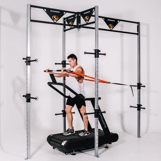 The Stroops MOFrame Movement Optimizer Rehabilitation Frame is a large rectangular training frame with multiple adjustable resistance band anchor points positioned at different heights around the structure. The frame is designed for gait training, movement correction, posture support, rehabilitation, and resistance training.