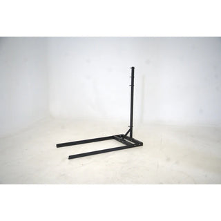 A black flat self-propelled motorless treadmill with a low-profile steel frame, slatted running belt, front support handles, and a vertical steel spine positioned behind the treadmill. The system can be configured with optional resistance training accessories including the Base Slastix® Adjustable Anchor, Universal Swivel Belt XL, and Optitail® Anchoring System for performance training and rehabilitation applications.
