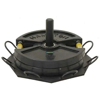 The Stroops SRPBASE Portable Base is a low-profile black octagonal steel ground anchor with eight evenly positioned connection points around its perimeter and a central area for adding weight plates. Its compact design is intended for portable group resistance training and floor-based exercises.