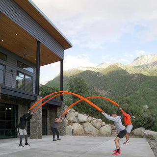 The Stroops Son of the Beast consists of two sleeved elastic battle ropes with handles, available in black or orange and in four resistance levels, with an Original pair or Pro package option.