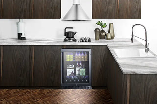 Modern kitchen with dark wood cabinets, marble countertops, and a Summit ALBV2466 24" Wide Built-In Beverage Cooler.
