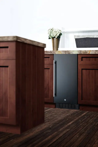 Summit ALR15B 15" Wide Built-In All-Refrigerator built into wooden kitchen cabinetry with a white wall and countertop in the background.