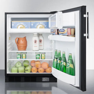Open Summit BKRF663BBIADA 24" Wide Break Room Refrigerator-Freezer displaying various food items including bottles, fruits, and vegetables.