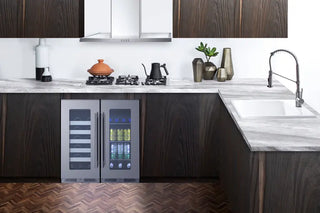 Modern kitchen with dark wood cabinets, Summit CL156BV1CSSLHD 15" Wide Built-In Beverage Centers, and marble countertops.