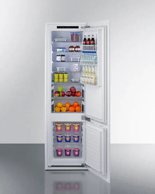 Open Summit FFBF11NT 24" Wide Fully Integrated Bottom Mount Refrigerator-Freezer with food items on a white background