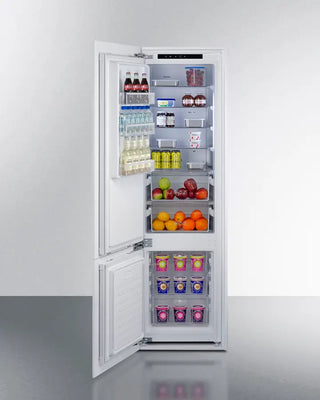 Open Summit FFBF11NTLHD 24" Wide Fully Integrated Bottom Mount Refrigerator-Freezer with food items on a white background