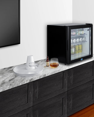Summit MB43GL glass door minibar on a marble counter in a living room setting