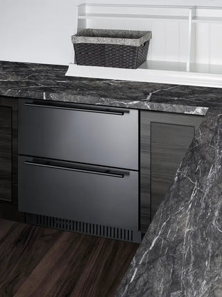 Summit SPR275OS2D built-in outdoor refrigerated drawer unit installed beneath a stone countertop. The stainless steel dual-drawer refrigerator integrates seamlessly into outdoor cabinetry, providing convenient cold storage for beverages, fresh food, and entertaining essentials in modern outdoor kitchen spaces.